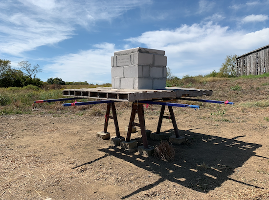 He Spirit's Work Is Shared Lifting, Hand-split and engraved Indiana limestone, fabricated steel, metal wheelbarrow handles, found pallet wood, rope, and cement, 2019. Located at Josephine Sculpture Park in Frankfort, KY. Photo courtesy of the artist.