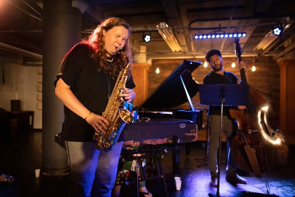 Sarah Hanahan playing saxophone with a jazz combo